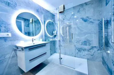 a bathroom with a sink and a shower with a mirror at Urban Essences by Lugo Collection in Lugo