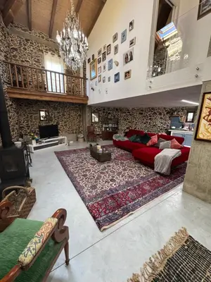 a living room with a red couch and a rug at Casa Vella do Nanín in Faramontaos