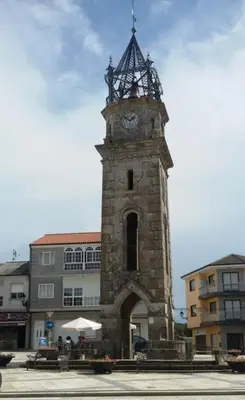 a tall tower with a clock on top of it at Casa Diaz in Cea
