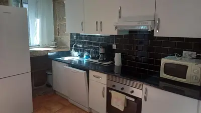 a kitchen with a sink and a microwave at Casa Diaz in Cea