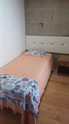 a bed with two pillows on it in a room at Casa Diaz in Cea