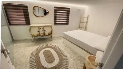 a small bedroom with a bed and a mirror at Casa de Conxo in Santiago de Compostela