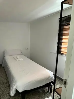a small bedroom with a bed and a bunk bed at Casa de Conxo in Santiago de Compostela