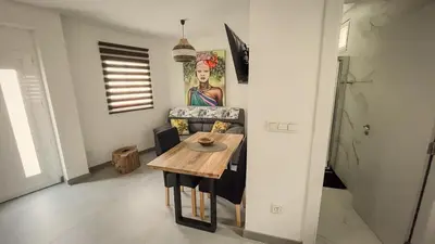 a living room with a table and a couch at Casa de Conxo in Santiago de Compostela