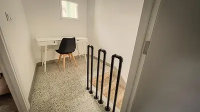 a stairway with a black chair and a desk at Casa de Conxo in Santiago de Compostela