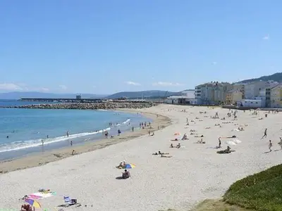 a large group of people on a beach at EnBURELA Playa in Burela de Cabo