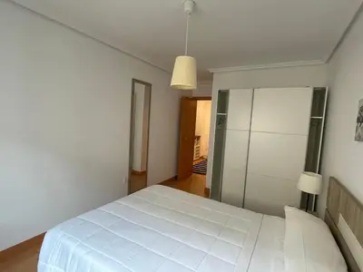a bedroom with a large white bed in a room at EnBURELA Playa in Burela de Cabo