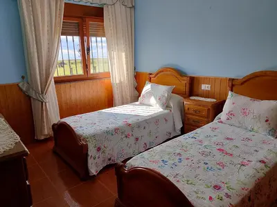 a bedroom with two beds and a window at Casa Las Catedrales Rochela in Devesa