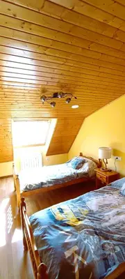 two beds in a room with a wooden ceiling at EnFOZ Duplex En La Playa in Foz