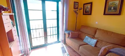 a living room with a couch and a sliding glass door at EnFOZ Duplex En La Playa in Foz