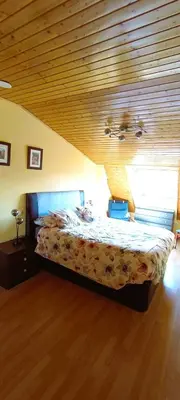 a bedroom with a bed with a wooden ceiling at EnFOZ Duplex En La Playa in Foz