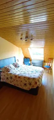 a bedroom with a bed and a wooden ceiling at EnFOZ Duplex En La Playa in Foz