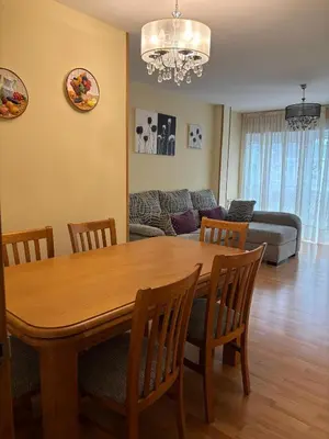 a living room with a wooden table and chairs at Alojamiento Morriña in O Pedrouzo