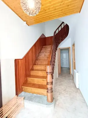 a staircase in a house with a wooden stair case at Casa das Mariñas in Viveiro