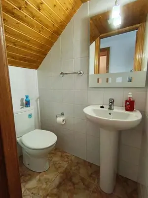 a bathroom with a toilet and a sink at Casa das Mariñas in Viveiro