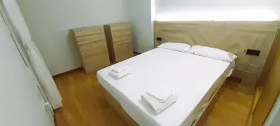 a bedroom with a white bed with two white pillows at EnFOZ Tus Mejores Vacaciones, Playa Piscina y Parking in Foz