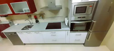 a small kitchen with a sink and a refrigerator at EnFOZ Tus Mejores Vacaciones, Playa Piscina y Parking in Foz