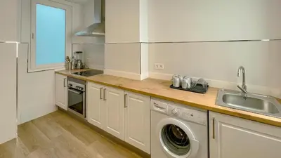 a kitchen with a sink and a washing machine at Jackson 3 in Lugo