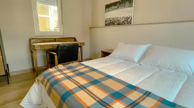 a bedroom with a bed and a desk and a chair at Jackson 3 in Lugo