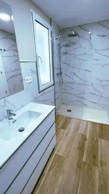 a white bathroom with a sink and a shower at Jackson 3 in Lugo