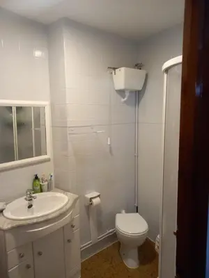 a white bathroom with a toilet and a sink at Puerto de Burela in Burela de Cabo