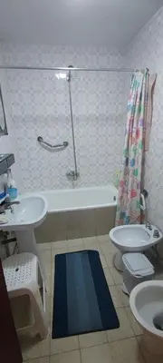 a bathroom with a sink and a tub and a toilet at Rosalia Rooms in A Estrada