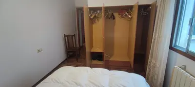 a bedroom with a closet and a bed in it at Rosalia Rooms in A Estrada