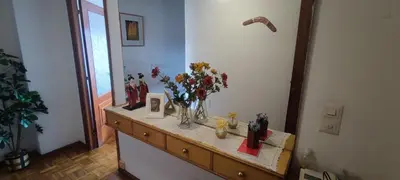 a table with a vase of flowers on top of it at Rosalia Rooms in A Estrada