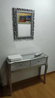 a table with a mirror on a wall with a mirror at Apartamento Rio Sar garaje incluido in Santiago de Compostela