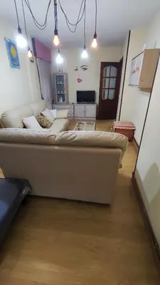 a living room with a large couch in a room at Apartamento Rio Sar garaje incluido in Santiago de Compostela
