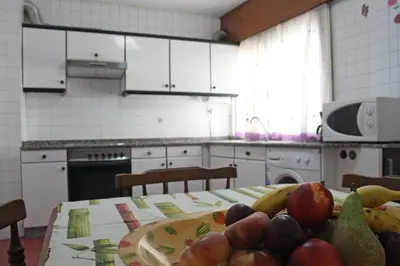 a kitchen with a table with fruit on it at Apartamento Rio Sar garaje incluido in Santiago de Compostela