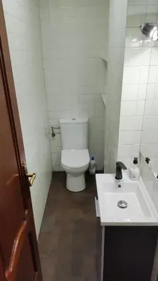 a bathroom with a white toilet and a sink at Apartamento Rio Sar garaje incluido in Santiago de Compostela