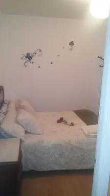 a bedroom with two beds with flowers on the wall at Apartamento Rio Sar garaje incluido in Santiago de Compostela
