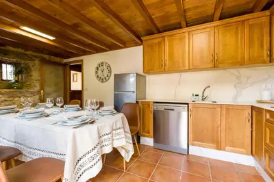 a kitchen with a table with wine glasses on it at A Casa do Carpinteiro