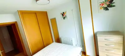 a small bedroom with a bed and a dresser at EnSAN CIPRIAN Con Playa Piscina y Parking in San Ciprián