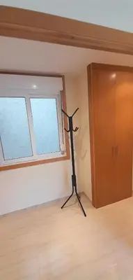 a black tripod in a room with a window at EnSAN CIPRIAN Con Playa Piscina y Parking in San Ciprián