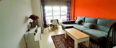 a living room with a couch and a table at EnSAN CIPRIAN Atico en Urb Río Cobo in San Ciprián
