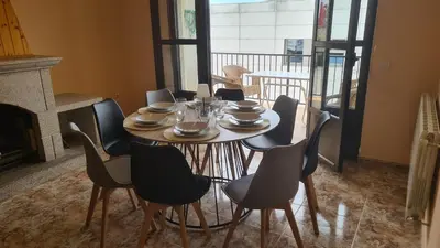 a dining room with a table and chairs and a fireplace at Casa Alba in Puebla de Sanabria