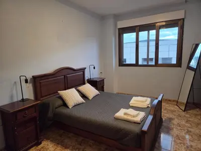 a bedroom with a bed with two towels on it at Casa Alba in Puebla de Sanabria