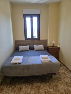 a bedroom with a bed with two towels on it at Casa Alba in Puebla de Sanabria