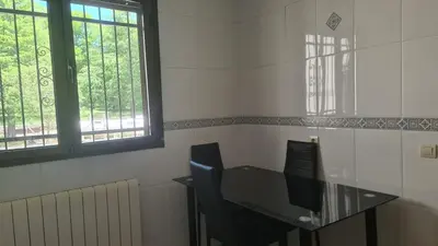 a room with a glass table and two chairs at Casa Alba in Puebla de Sanabria