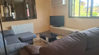a living room with a couch and a tv at Casa Alba in Puebla de Sanabria