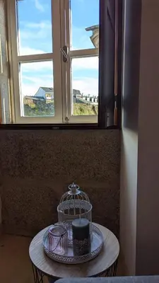 a tray with a hat on a table in front of a window at Cantiño 39 in Lugo