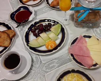 a table topped with plates of food and drinks at Hostal Martin - Sanabria in Ribadelago