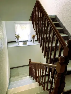 a staircase with two vases on a window sill at EnVIVEIRO Villa Bonita in Viveiro