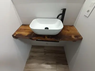 a bathroom with a white sink on a wooden table at Casa Do Castelo in Lugo