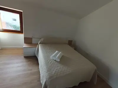 a bedroom with a bed with a towel on it at Casa Do Castelo in Lugo