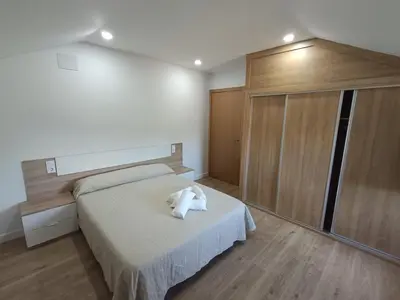 a bedroom with a bed with a white towel on it at Casa Do Castelo in Lugo