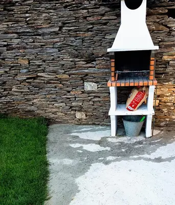 a bird feeder sitting next to a brick wall at Casa Do Castelo in Lugo