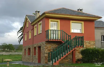a house with a staircase on the side of it at Apartamentos Bouso in Villaframil